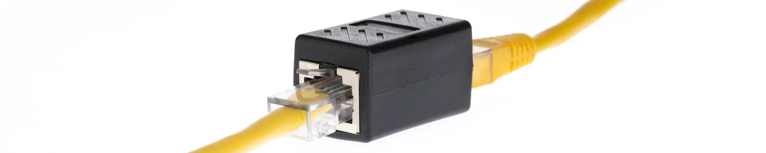 A black network coupler with two yellow network cables